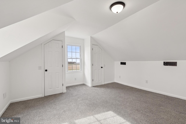 bonus room with carpet, baseboards, and vaulted ceiling