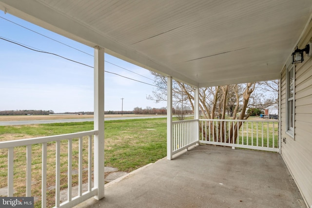 view of patio / terrace with a rural view and a porch