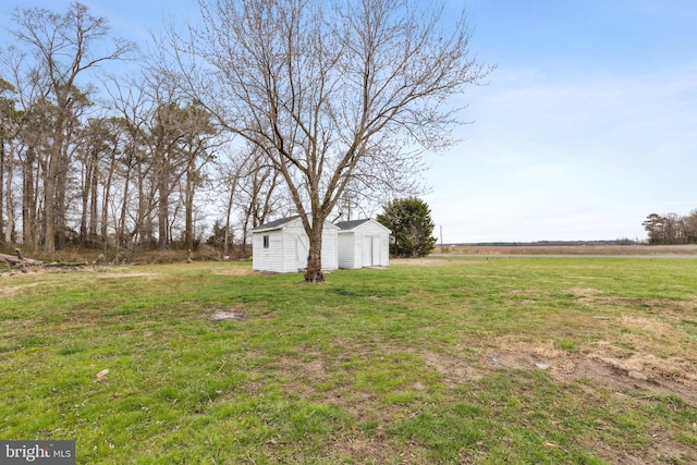 view of yard with an outdoor structure and a shed