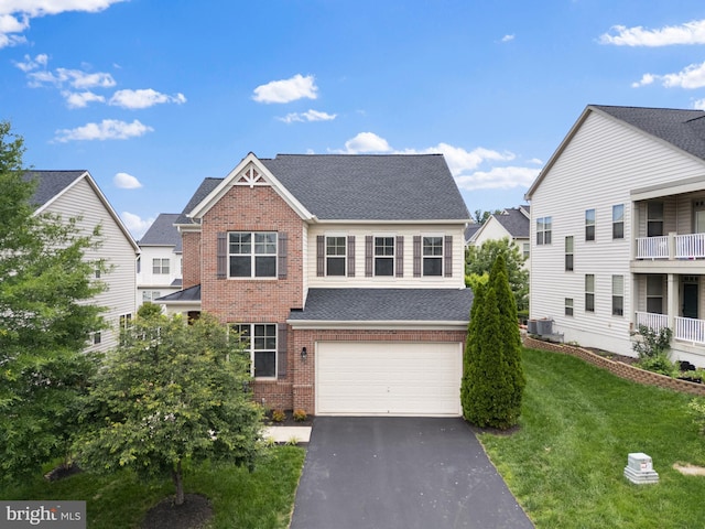 42694 Chisholm, Broadlands, VA 20148 - view of front of house featuring brick siding, asphalt driveway, an attached garage, a front lawn, and a shingled roof