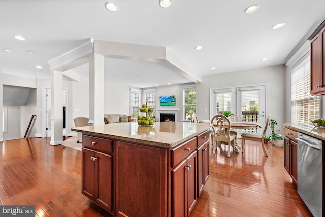 42694 Chisholm, Broadlands, VA 20148 - kitchen with dishwasher, a warm lit fireplace, open floor plan, light stone countertops, and recessed lighting