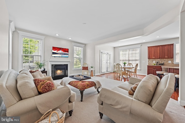 42694 Chisholm, Broadlands, VA 20148 - living area with recessed lighting, plenty of natural light, a glass covered fireplace, and baseboards