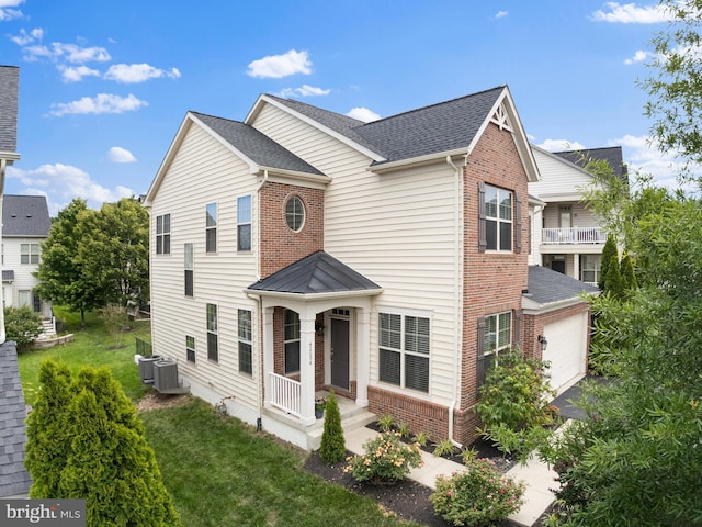 42694 Chisholm, Broadlands, VA 20148 - view of front facade with brick siding, a garage, roof with shingles, and a front yard