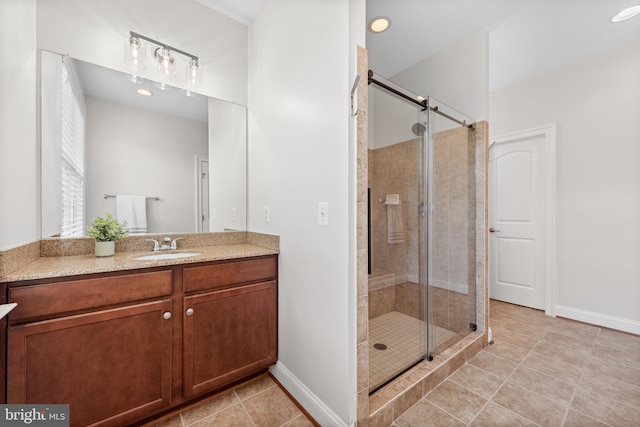 42694 Chisholm, Broadlands, VA 20148 - bathroom featuring a stall shower, vanity, tile patterned floors, and baseboards