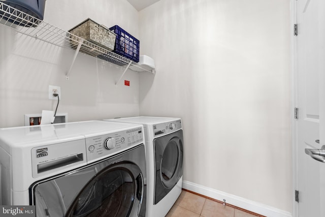 42694 Chisholm, Broadlands, VA 20148 - laundry room featuring separate washer and dryer, baseboards, and light tile patterned flooring