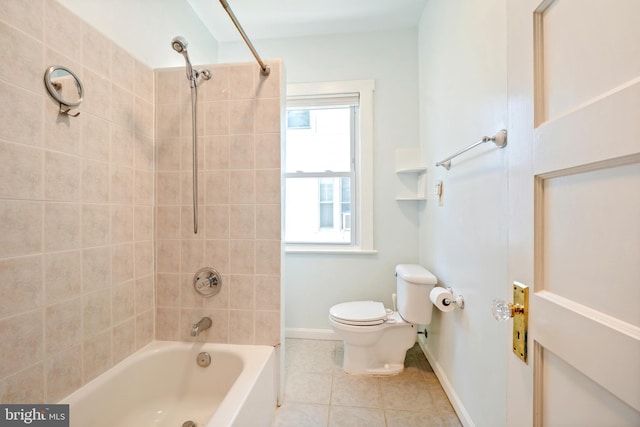 bathroom with toilet, tile patterned flooring, bathtub / shower combination, and baseboards