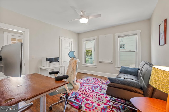 office space with baseboards, a ceiling fan, and wood finished floors