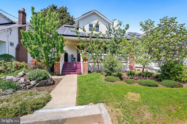 obstructed view of property featuring covered porch, a front lawn, and solar panels