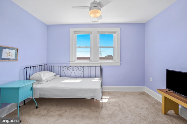 bedroom featuring visible vents, baseboards, a ceiling fan, and carpet floors