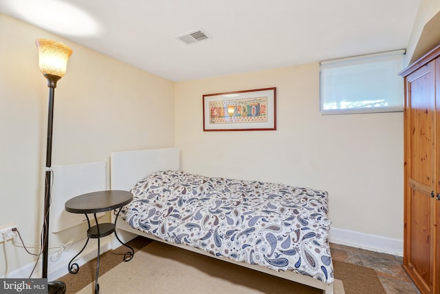 bedroom with baseboards and visible vents