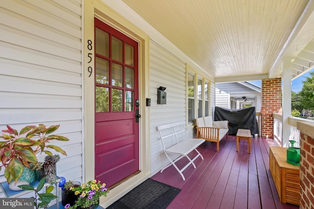 view of exterior entry featuring covered porch