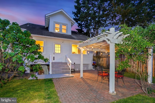 rear view of house featuring fence, a pergola, and a patio