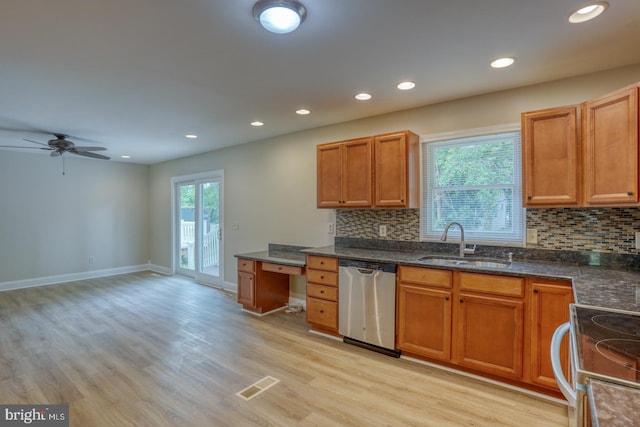 kitchen with dishwasher, a sink, backsplash, light wood-type flooring, and recessed lighting
