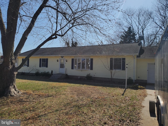 ranch-style home with a front lawn