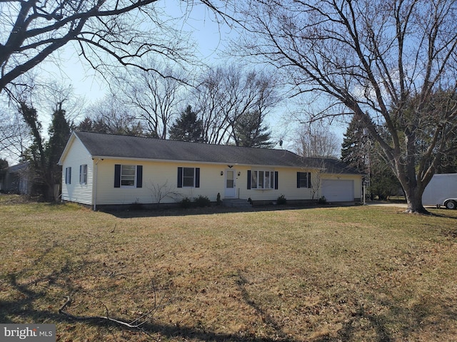 ranch-style home with a front lawn and an attached garage