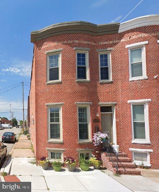 view of property with brick siding and entry steps