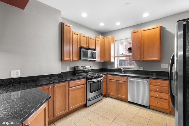 kitchen with recessed lighting, light tile patterned floors, a sink, and appliances with stainless steel finishes