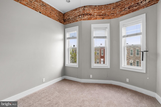spare room featuring baseboards and carpet