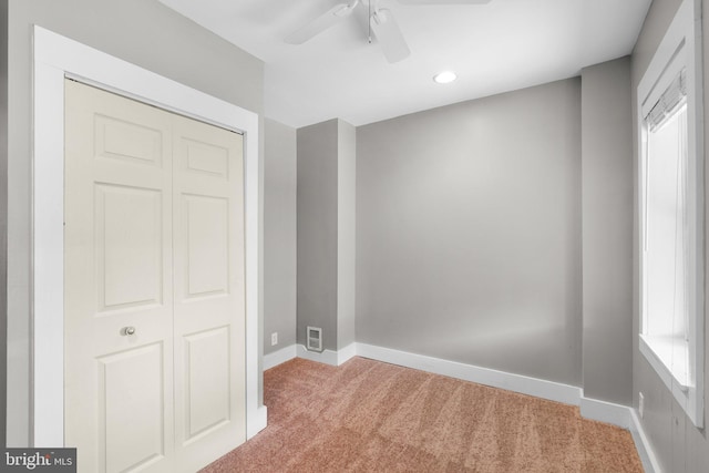 carpeted spare room featuring baseboards, a ceiling fan, and recessed lighting