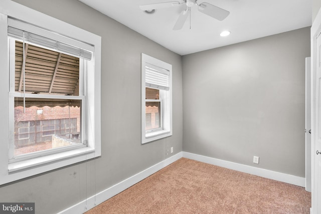 spare room with light colored carpet, ceiling fan, baseboards, and recessed lighting