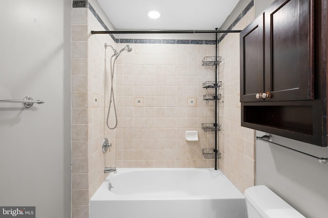 bathroom with toilet and bathing tub / shower combination