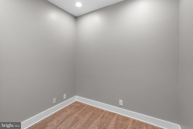 empty room with carpet flooring, baseboards, and recessed lighting