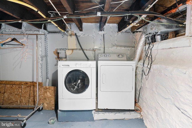 clothes washing area featuring laundry area and washing machine and dryer