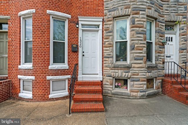 doorway to property featuring stone siding