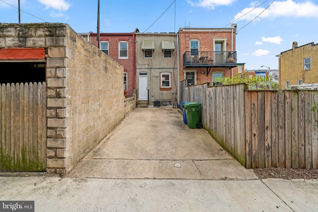 exterior space with brick siding and fence