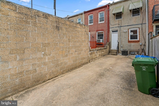 exterior space featuring fence, entry steps, and cooling unit