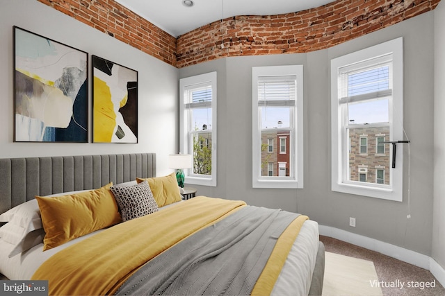 carpeted bedroom with baseboards and multiple windows