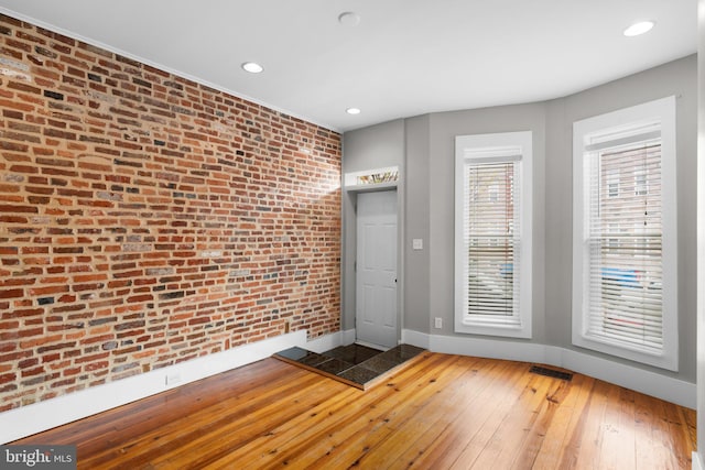 interior space featuring recessed lighting, hardwood / wood-style floors, visible vents, and baseboards