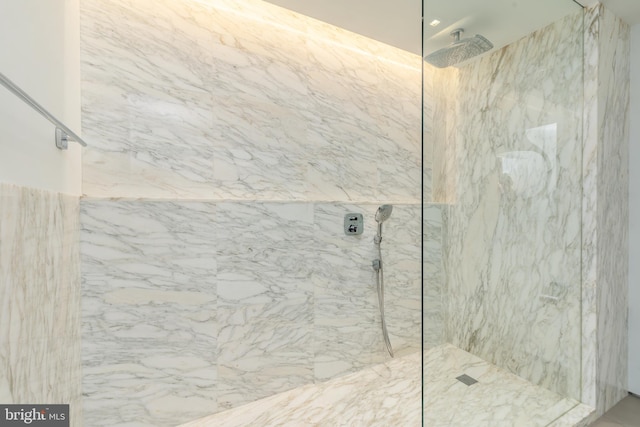 bathroom with a marble finish shower