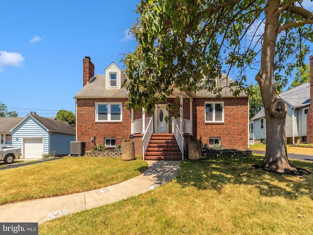 view of front of house with a front lawn, a chimney, cooling unit, and brick siding
