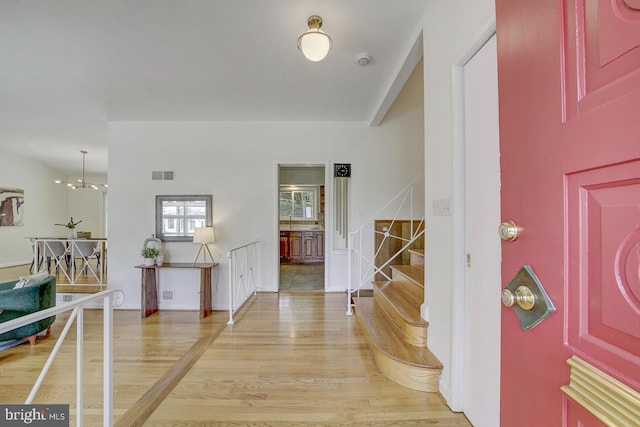 3217 Pauline Dr, Chevy Chase, MD 20815 - foyer entrance featuring stairway, light wood finished floors, and a chandelier