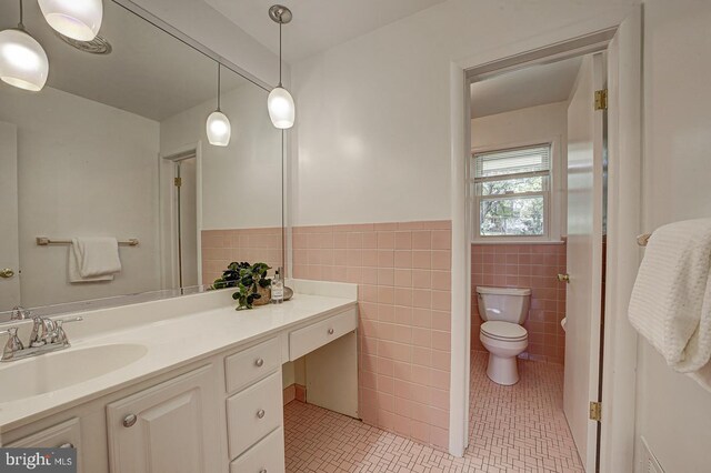 3217 Pauline Dr, Chevy Chase, MD 20815 - bathroom featuring tile patterned flooring, tile walls, vanity, and wainscoting