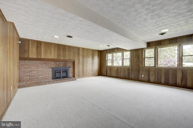 3217 Pauline Dr, Chevy Chase, MD 20815 - unfurnished living room with wooden walls, a textured ceiling, carpet, and a brick fireplace