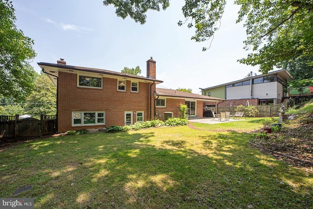 3217 Pauline Dr, Chevy Chase, MD 20815 - rear view of house with a patio area, brick siding, a chimney, and a fenced backyard