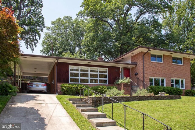 3217 Pauline Dr, Chevy Chase, MD 20815 - split level home with driveway, brick siding, a front yard, and a carport