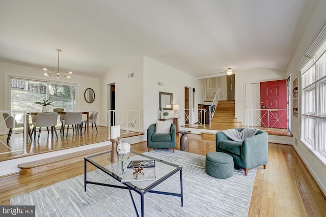 3217 Pauline Dr, Chevy Chase, MD 20815 - living room with wood finished floors, stairs, a chandelier, and vaulted ceiling