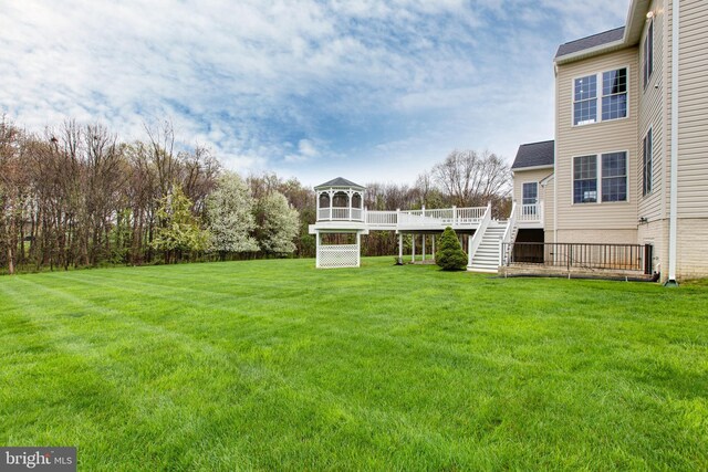 view of yard featuring stairway and a deck