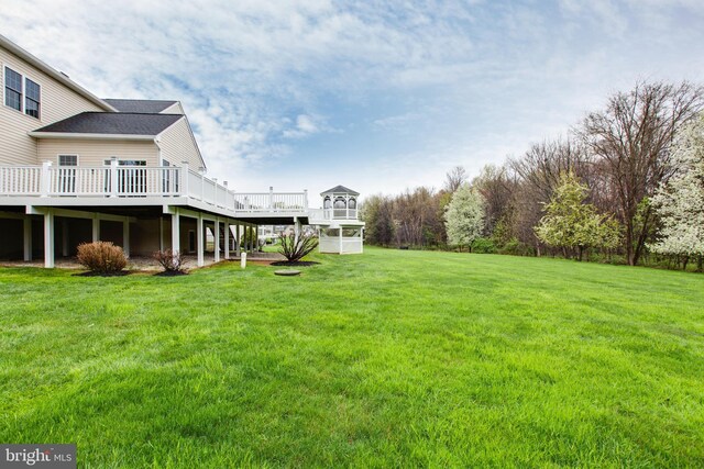 view of yard featuring stairway and a deck