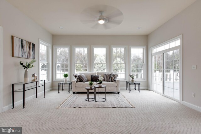 sunroom with baseboards, carpet flooring, and a wealth of natural light