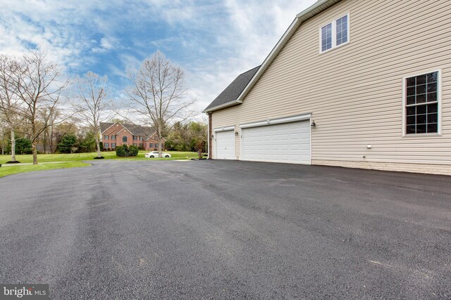view of side of property featuring driveway