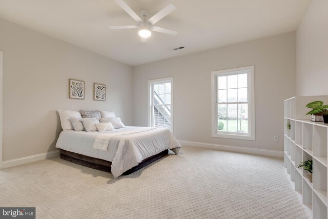 bedroom featuring baseboards, ceiling fan, carpet flooring, and visible vents