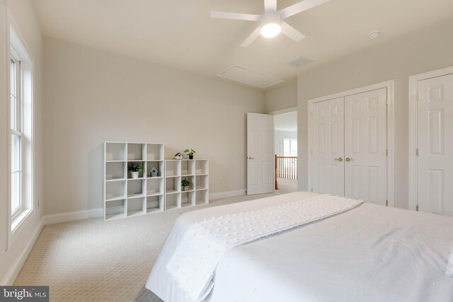 bedroom with baseboards, carpet, ceiling fan, and a closet