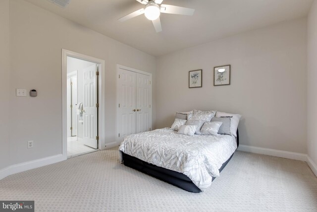 bedroom featuring baseboards, a ceiling fan, a closet, and light colored carpet