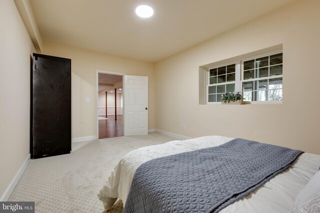 carpeted bedroom featuring baseboards