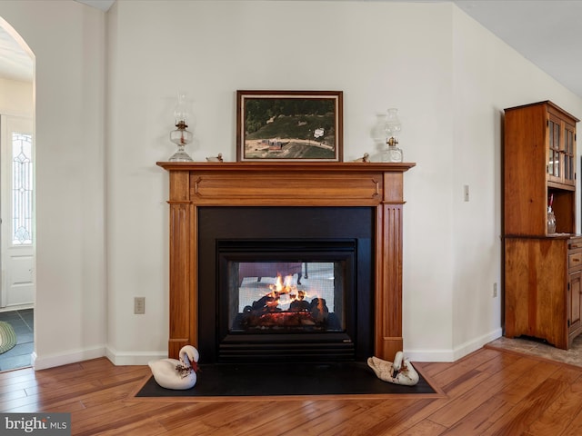 5409 Smith Creek Rd, New Market, VA 22844 - details featuring a multi sided fireplace, wood finished floors, arched walkways, and baseboards