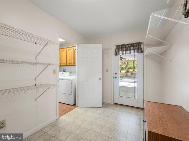 5409 Smith Creek Rd, New Market, VA 22844 - clothes washing area with baseboards, washing machine and clothes dryer, cabinet space, and light tile patterned floors